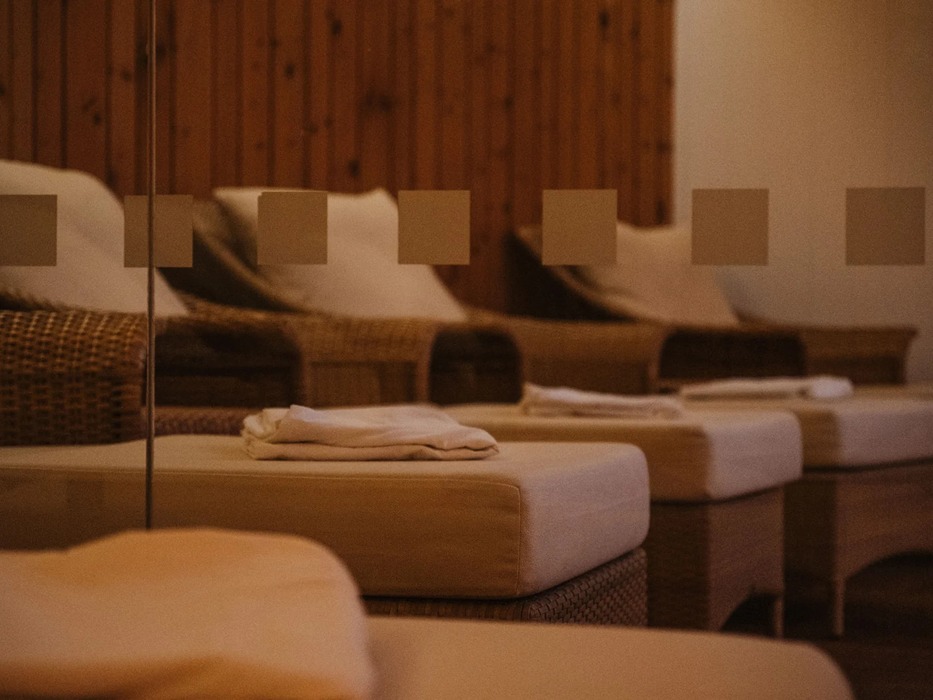 Cozy cushioned chairs with pillows in a wooden room