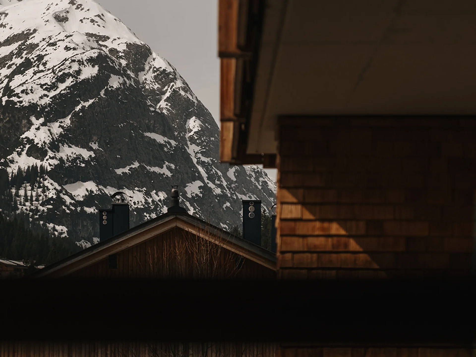 Wooden houses with snowy mountain in the background in a quiet village
